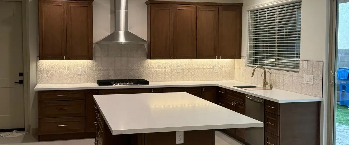 Modern kitchen remodel with large island, custom cabinets, and updated lighting