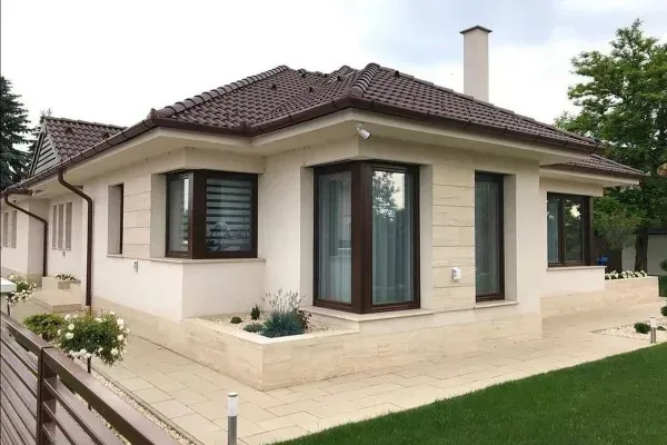 Modern single-story bungalow house with landscaped yard.