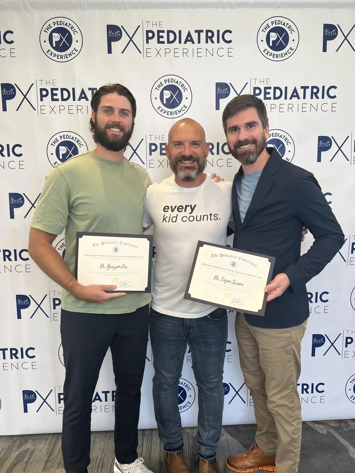 man in white shirt carrying boy