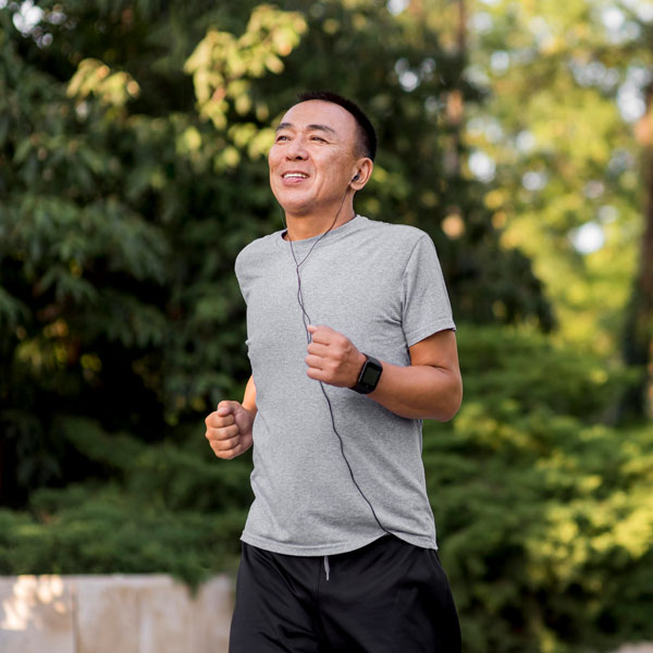 Active person running while listening to headphones