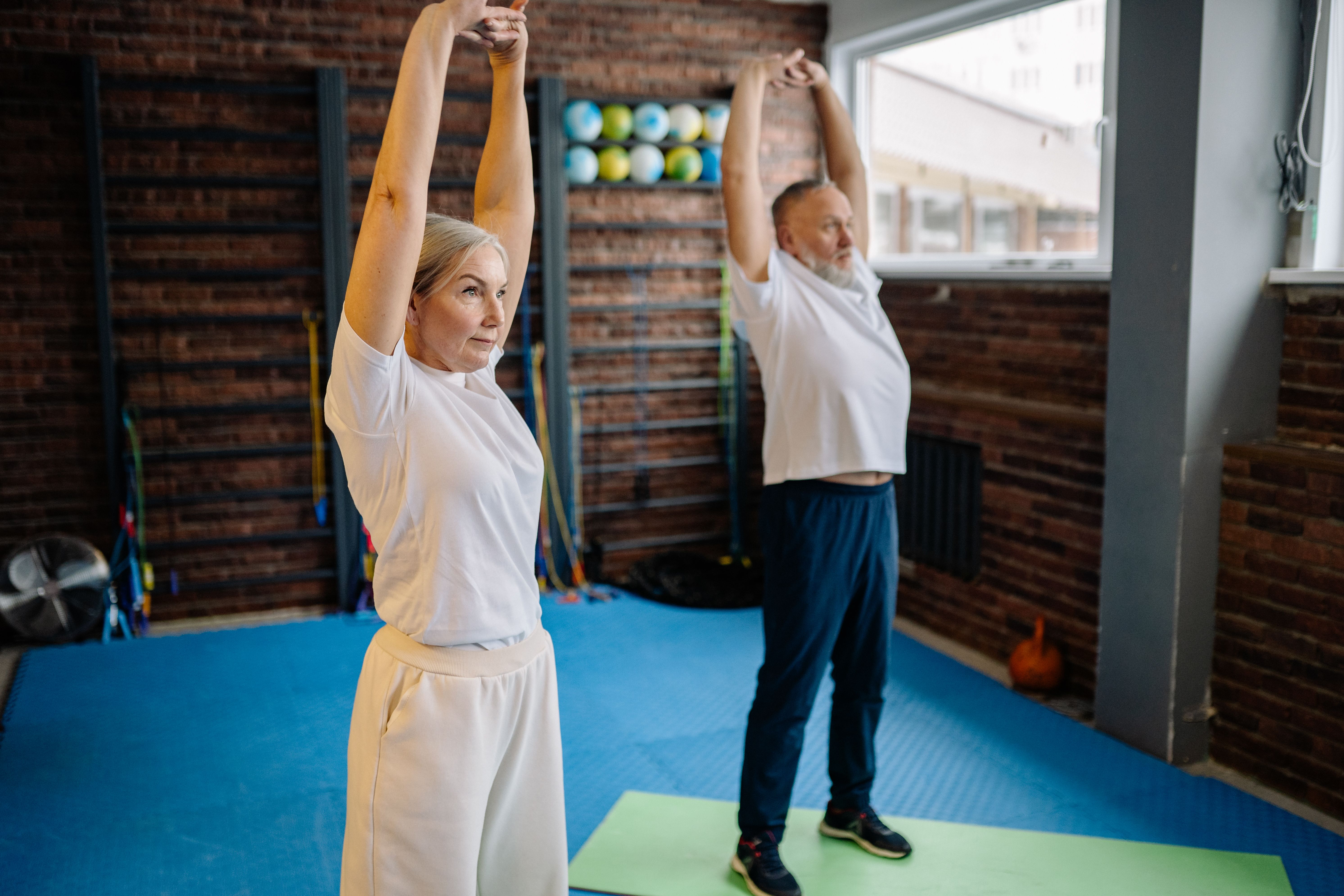 Man and woman actively stretching.