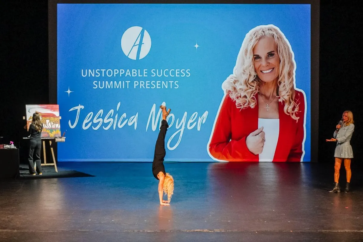 Jessica Moyer doing a handstand on stage