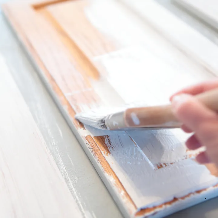 Picture of a cabinet being painted white