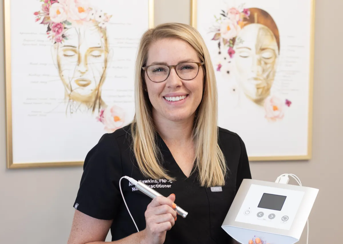 Owner of med spa displaying tool used for microneedling services as part of her skin treatment services.