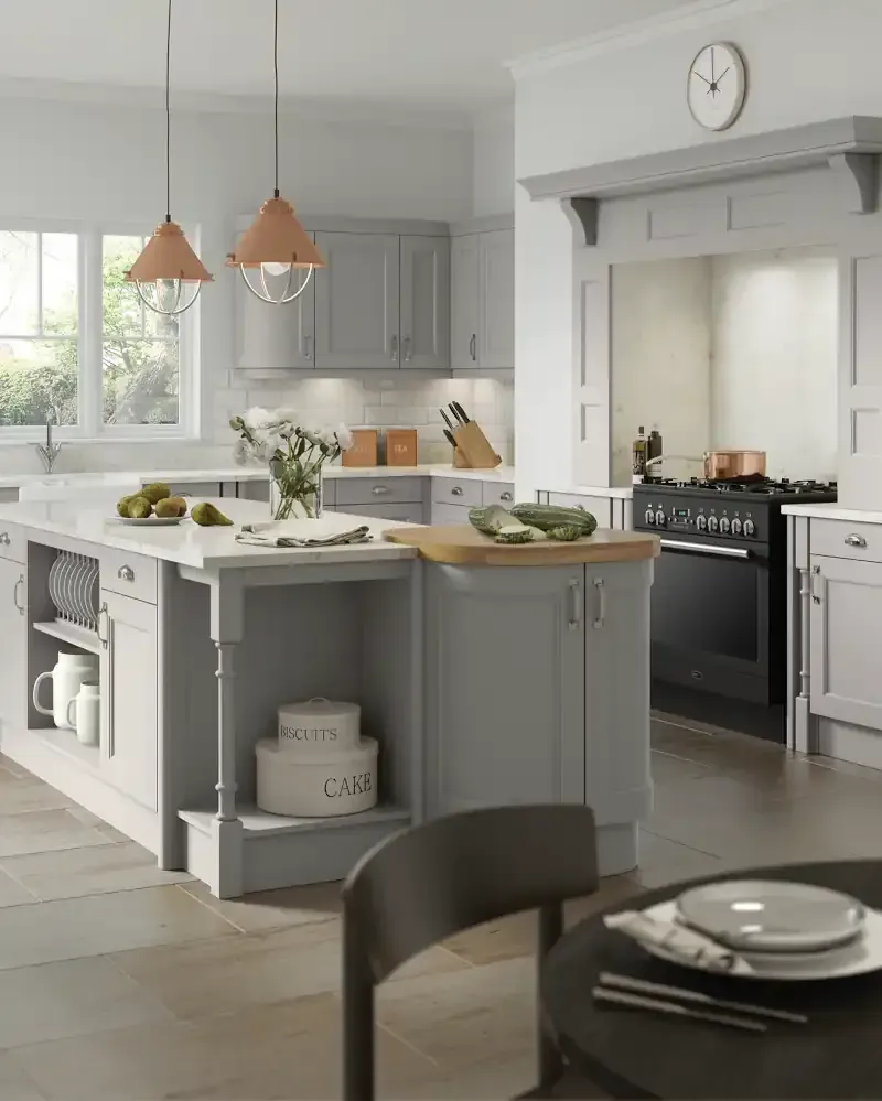 White handleless kitchen with black accent strips, corner window overlooking sea view, black tap, and wood flooring by Blueprint Kitchens