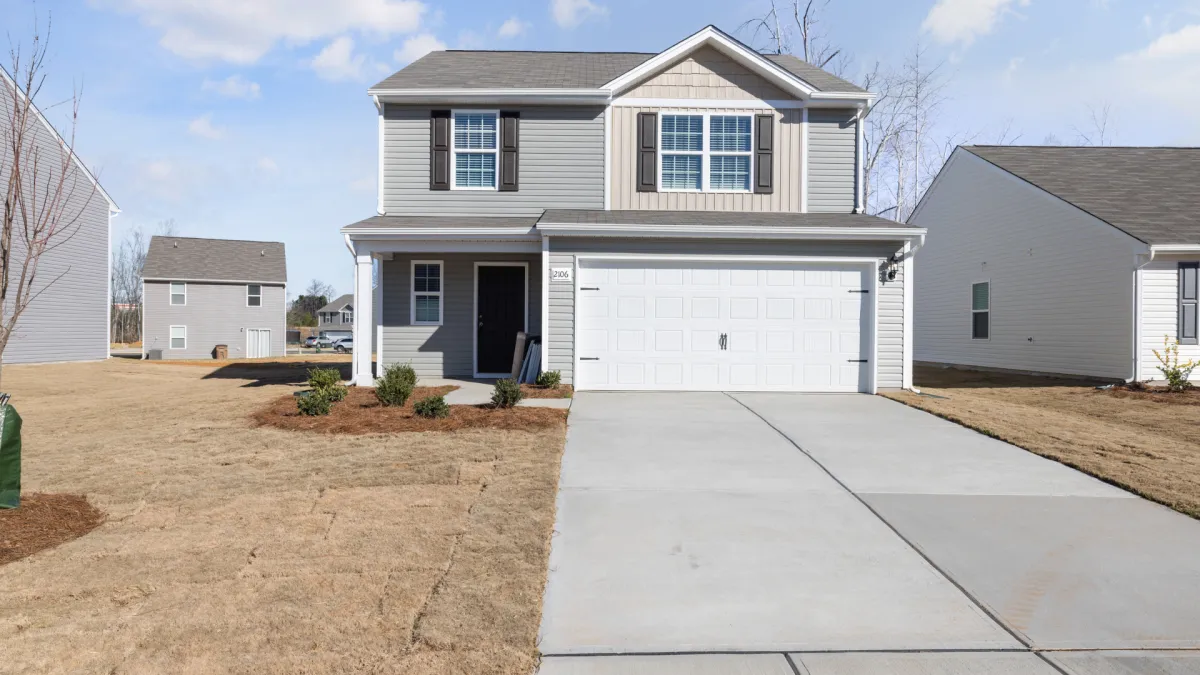 Finished residential concrete driveway leading to a two-car garage at a home in Aurora, Colorado