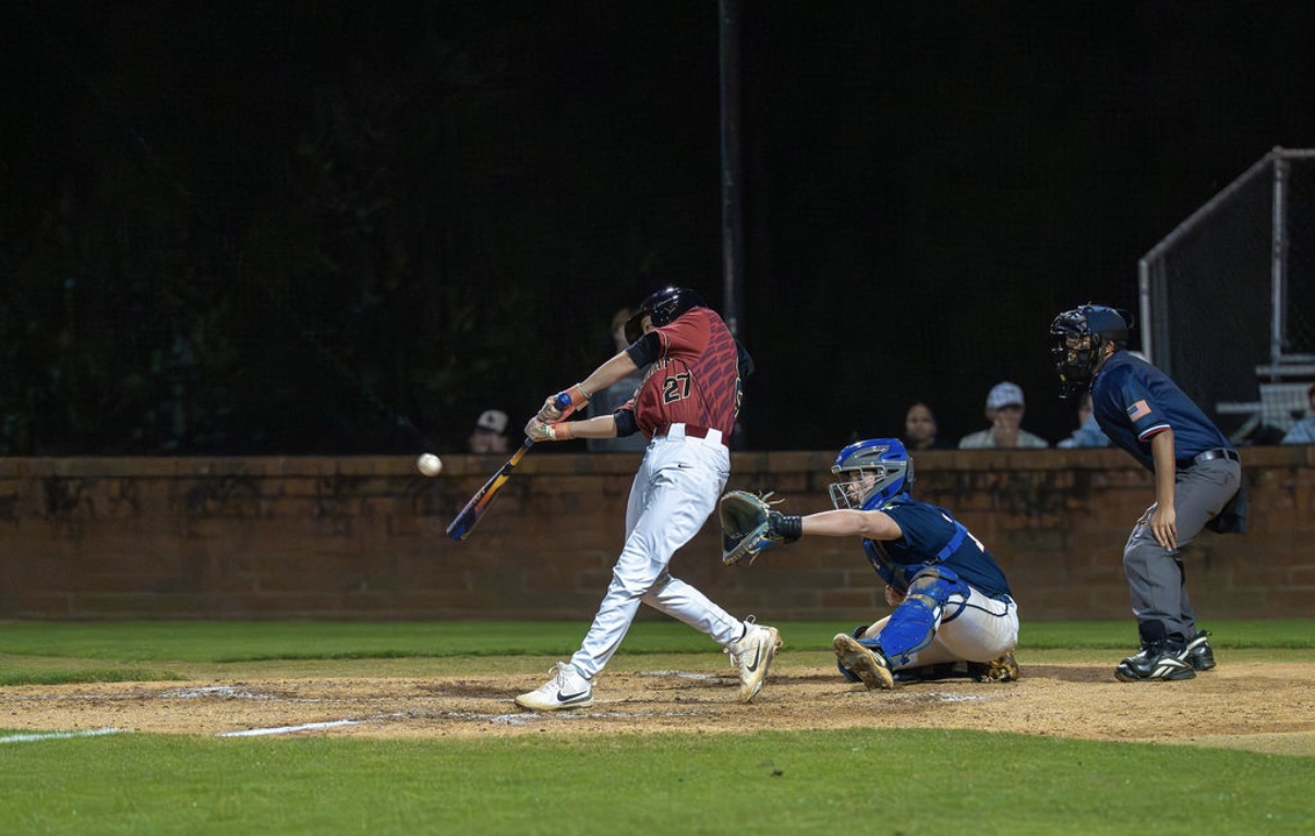 a black and white photo of a person holding a baseball bat