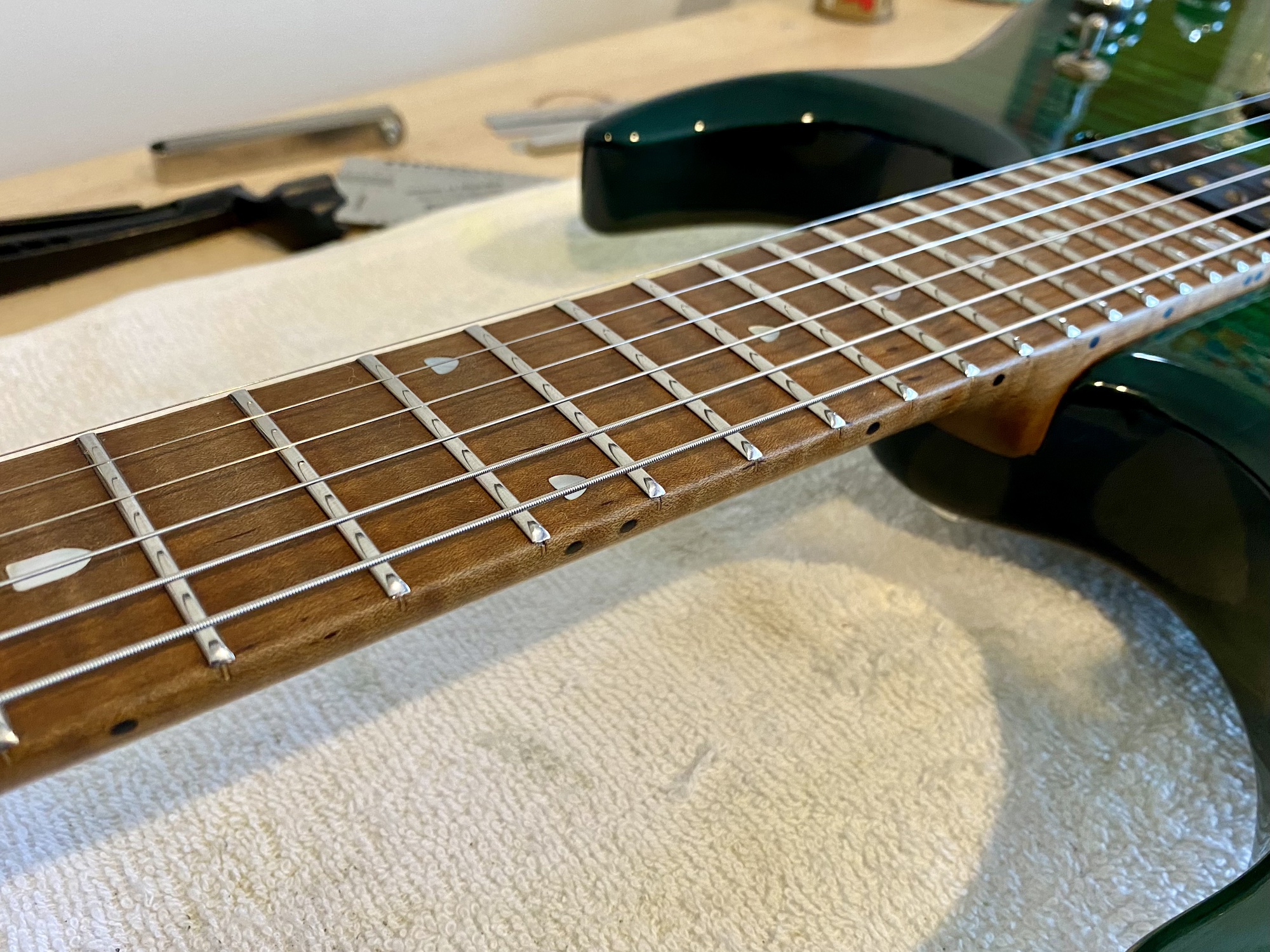 Electric guitar fretboard after precision setup and fret polishing