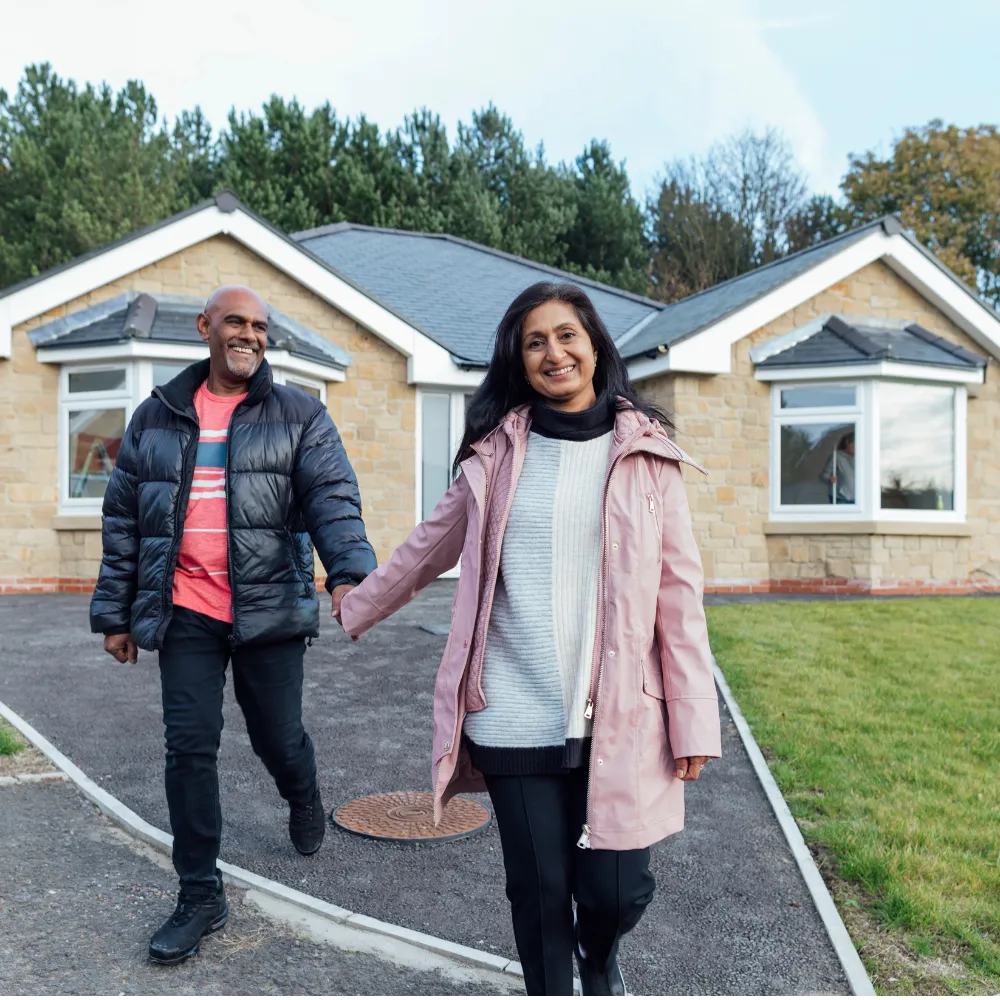 Homeowners representing a successful property sale with Peakwood Homes.