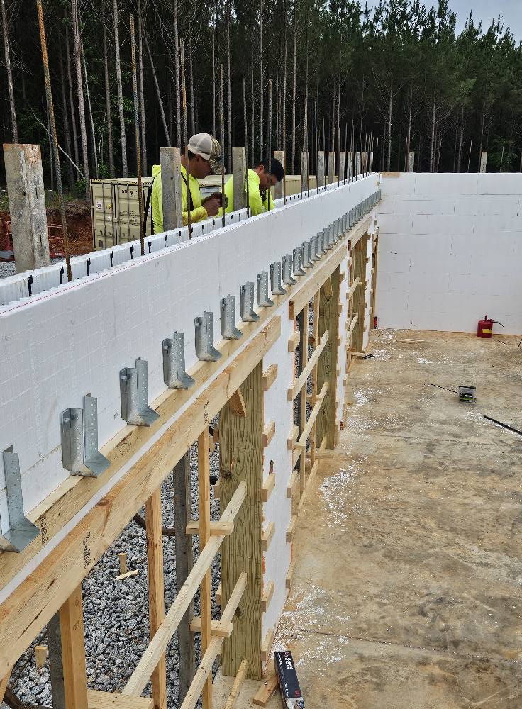 Burmon Building Products ICF joist hanger bracket applied to Stronghold ICF wall on Gulf Breeze, FL job site.