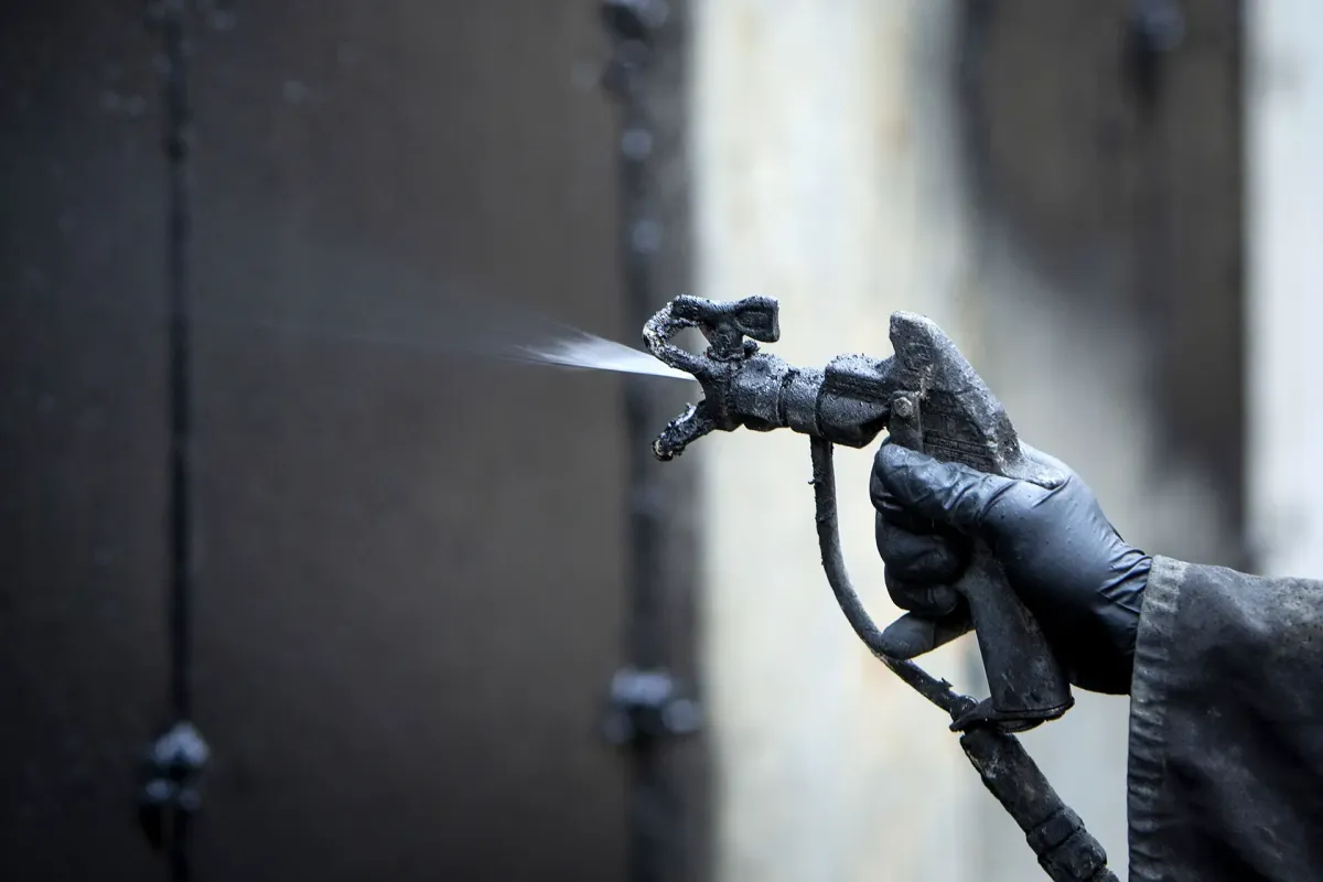 waterproofing spray on ICF basement wall during winter construction conditions of -10°F temperatures