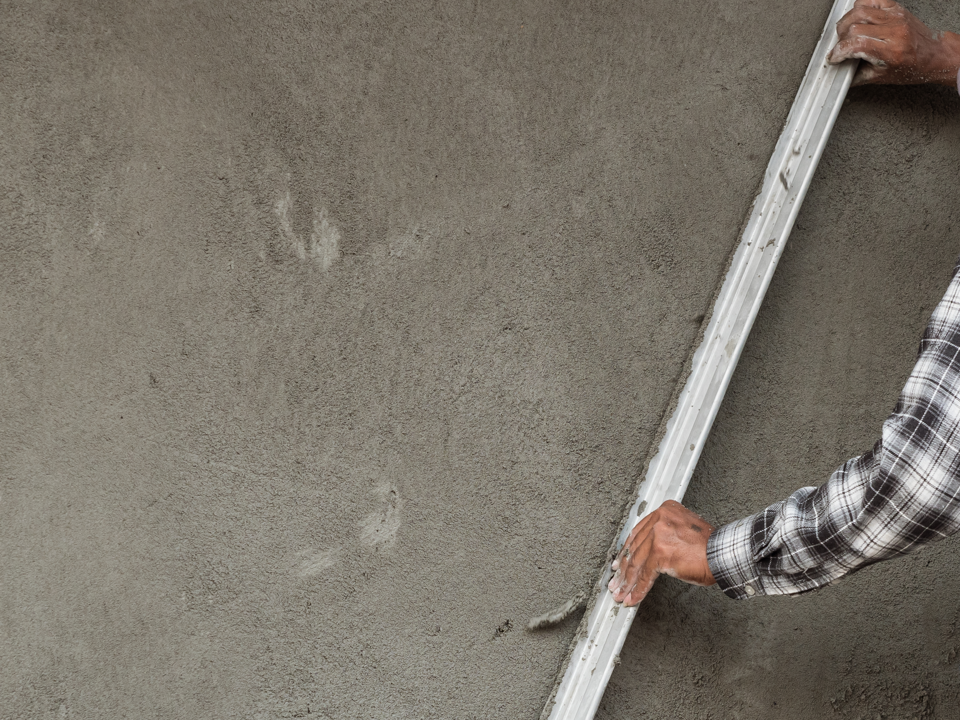 Man Applying Hulk Cementitious Stucco to Wall on Santa Fe, NM job site