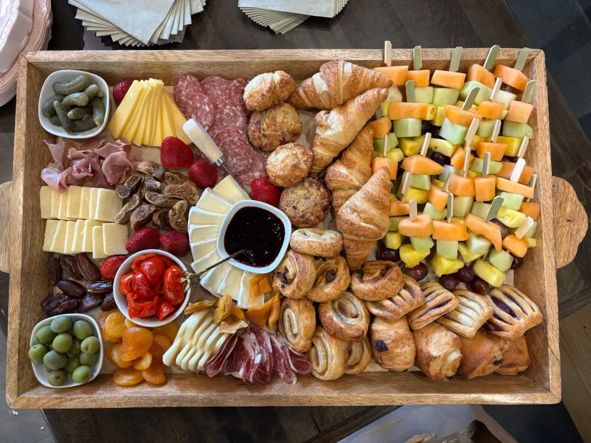 Large wooden charcuterie and pastry board showcasing the high-quality, made-to-order food and catering items prepared daily by the Stroll Cafe team.