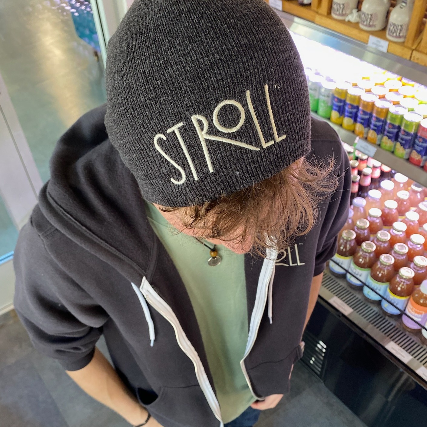 Stroll Cafe team member wearing a branded knit beanie, representing the friendly and casual work culture in Portsmouth, NH