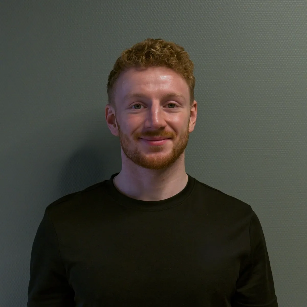 Portrait of Anna Berg, mid-40s, smiling professional in casual outdoor clothing, half-body against a neutral blurred background, natural lighting and approachable expression.