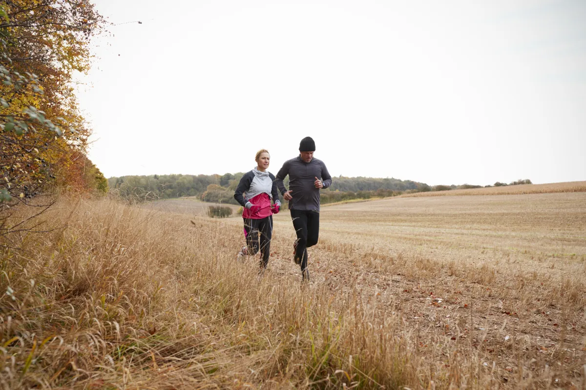 Mature couple running in the countryside