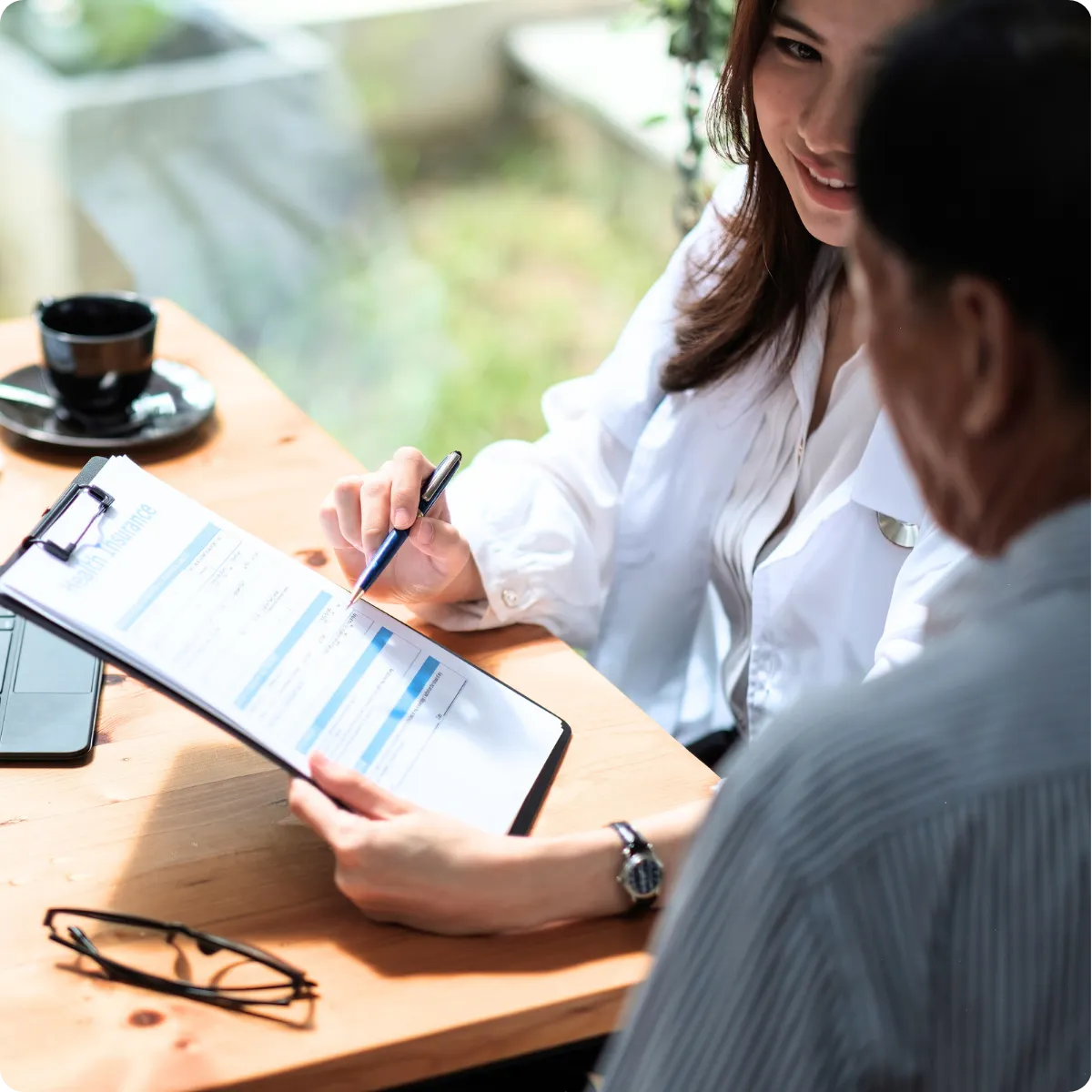 Chiropractor reviewing patient chart and treatment plan