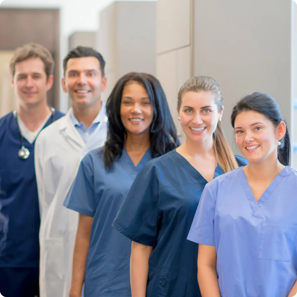 Plano chiropractor and friendly clinic staff smiling in uniform