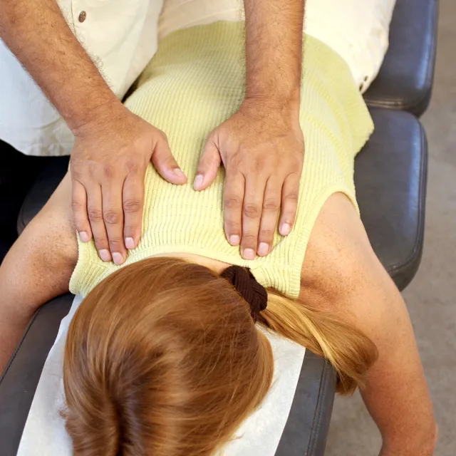 Patient receiving gentle spine and extremity adjustment