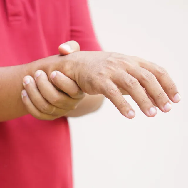 Patient holding numb arm in discomfort