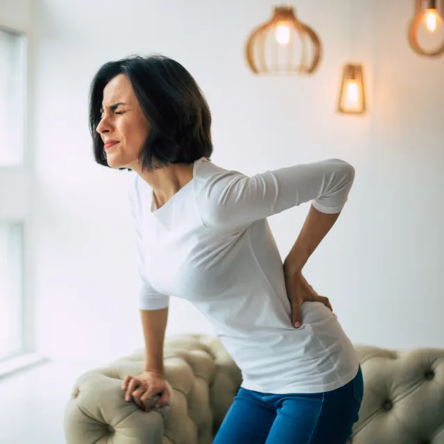 Woman clutching lower back in pain