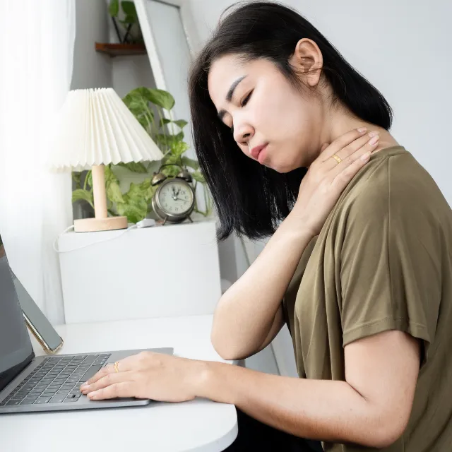 Woman stretching neck to relieve pain