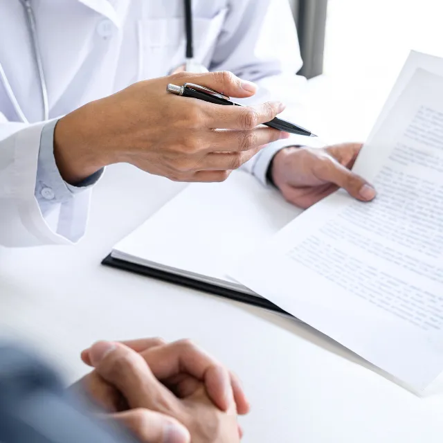 Plano chiropractor writing a personalized chiropractic treatment plan