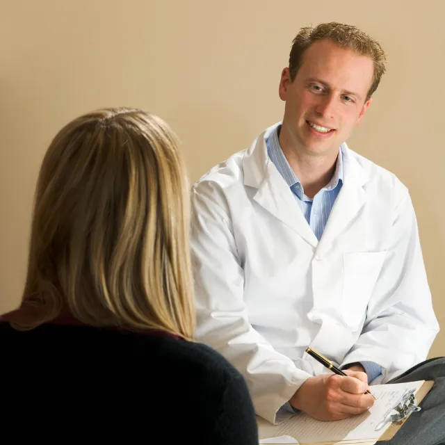 Plano chiropractor conducting a detailed assessment of patient’s posture and movement