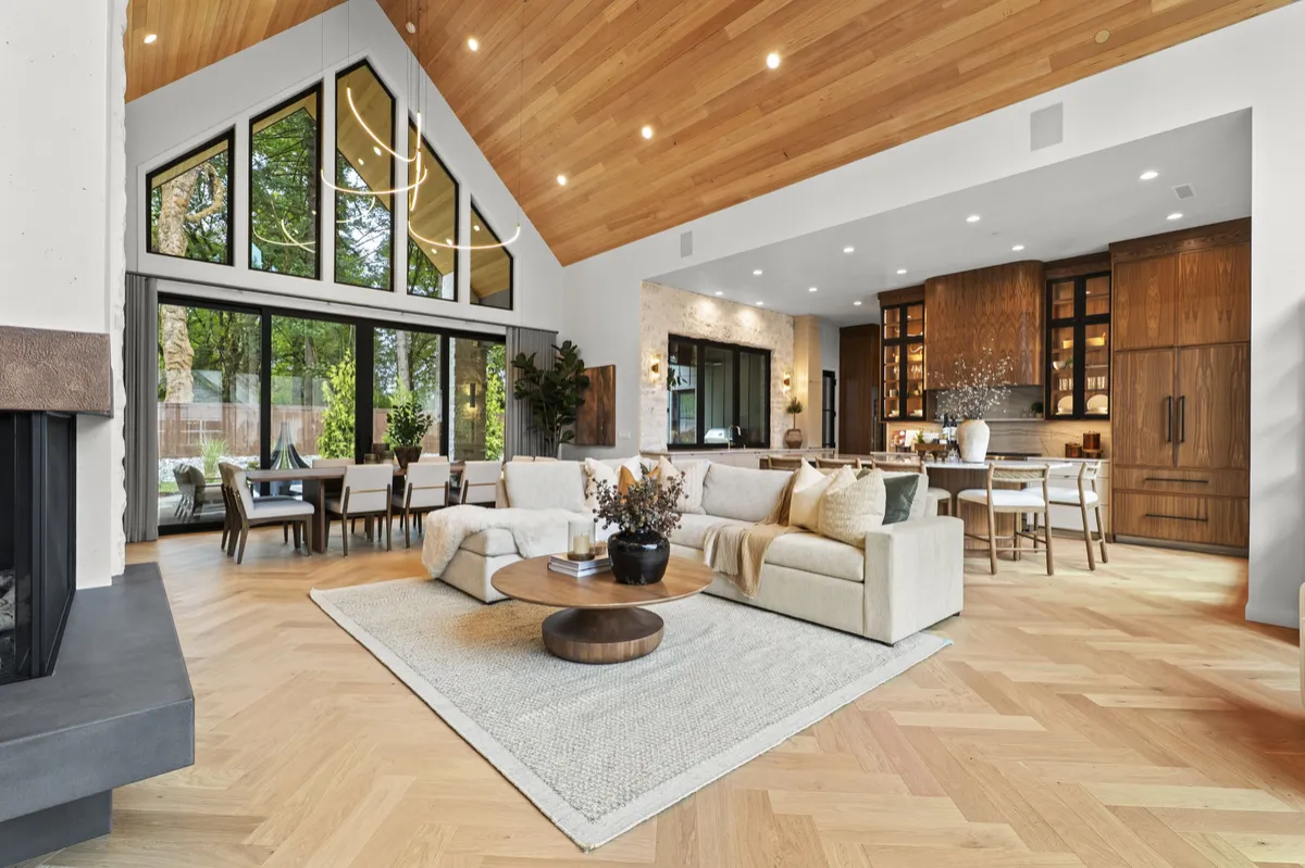 Open living room with vaulted wood ceiling and tall windows