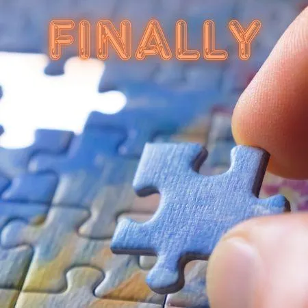 A man puts the last piece in a puzzle