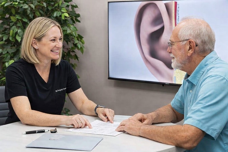 An Audiologist works with a patient in a modern practice environment