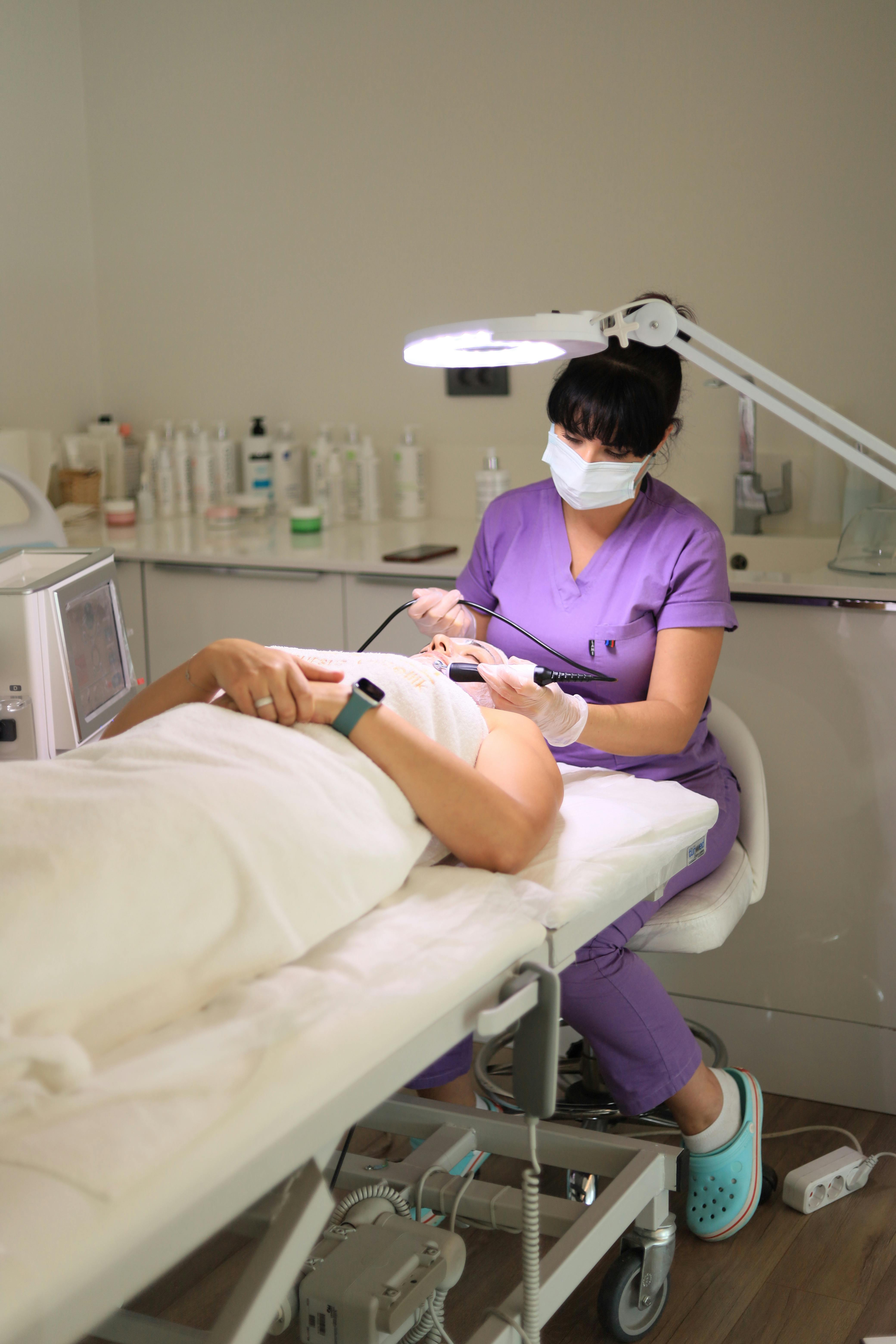 Wellness or spa professional performing a treatment on a client — representing beauty, esthetician, and wellness small business owners who qualify for Bayside Business Advisors funding and capital solutions in Miami.