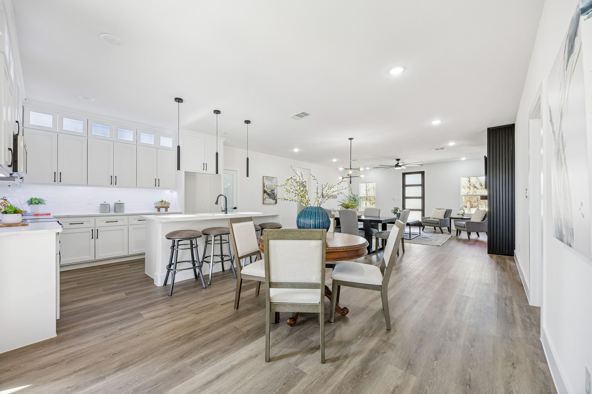 Custom kitchen with large island and pendant lighting by Texas Prime