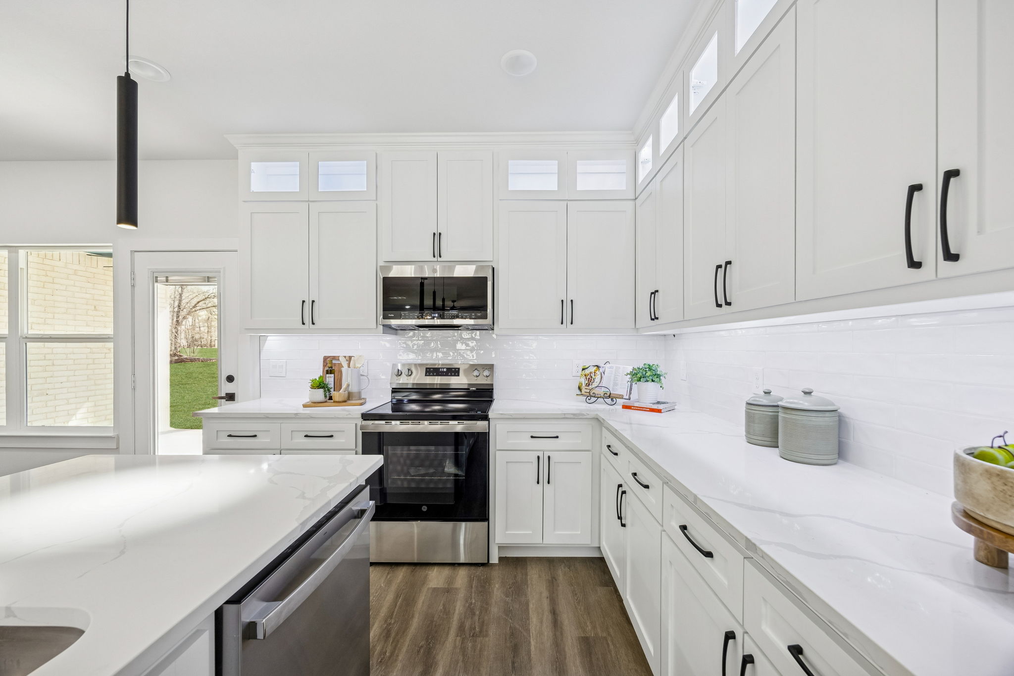Custom kitchen with large island and pendant lighting by Texas Prime