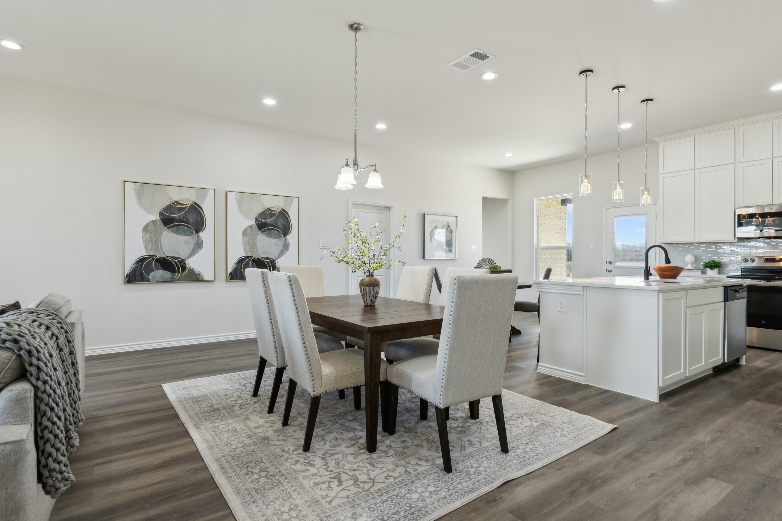Bright farmhouse dining area with large windows by Texas Prime