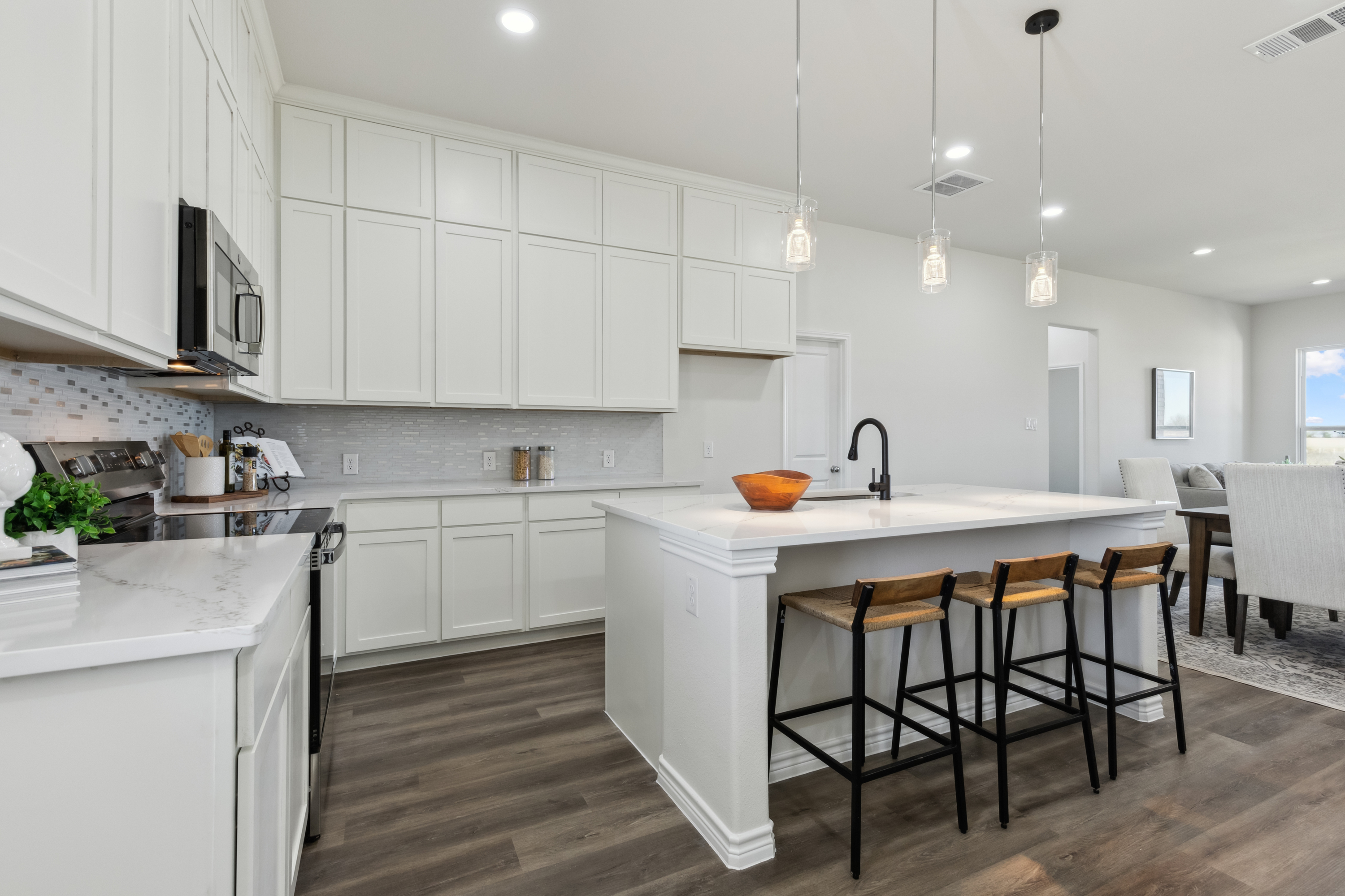 Bright farmhouse dining area with large windows by Texas Prime