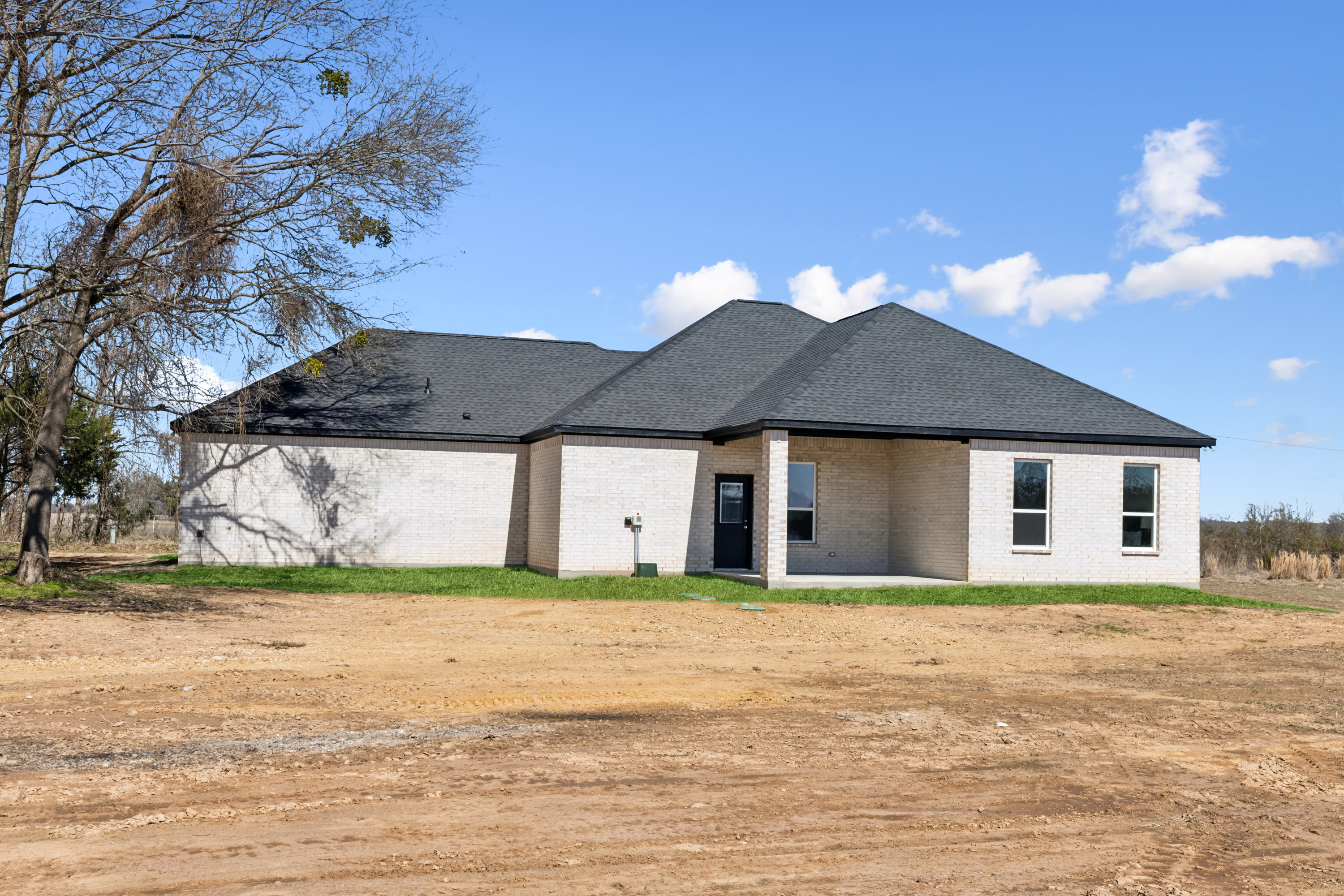 Texas Prime farmhouse kitchen with white cabinetry and wood beams