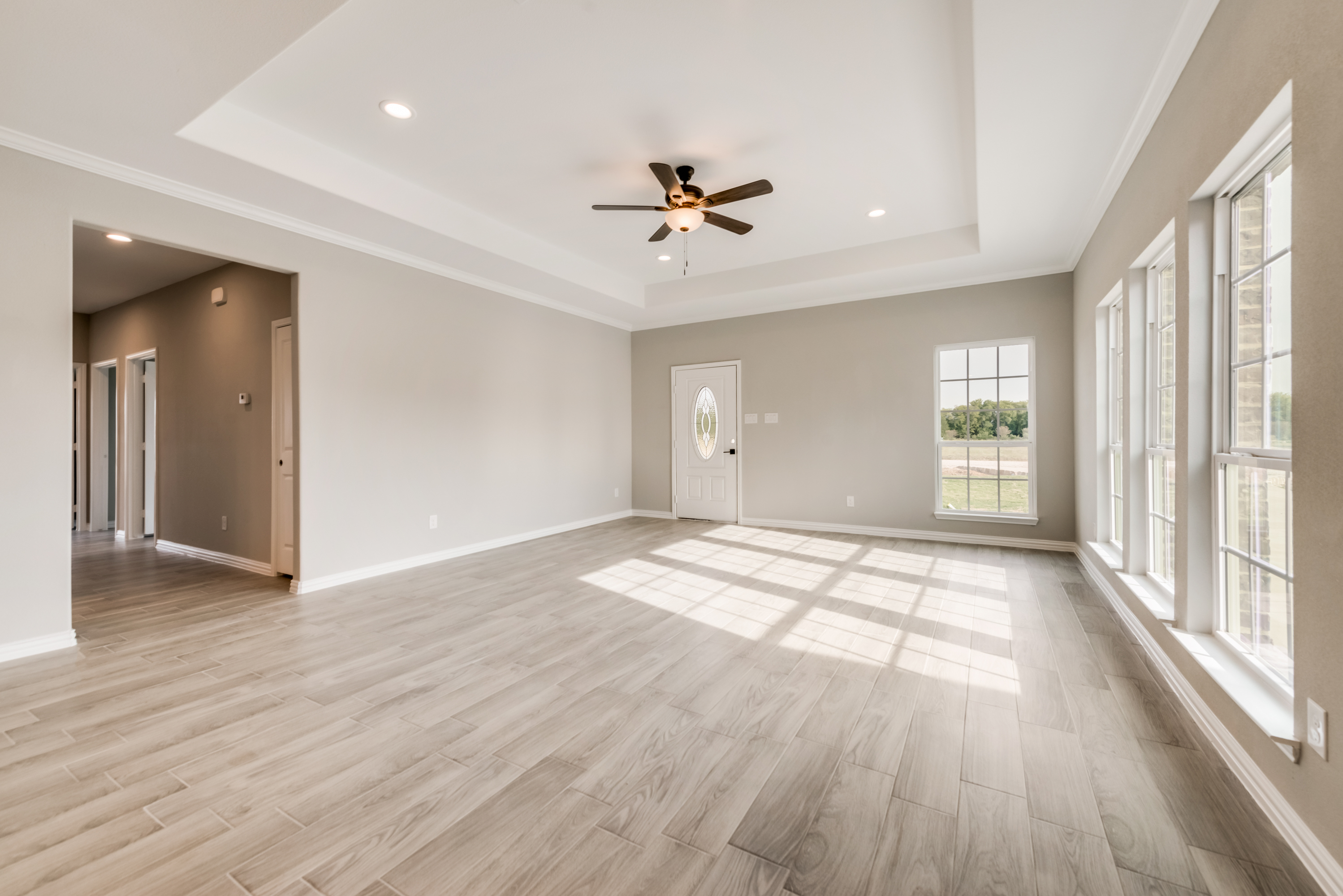 Warm ranch-style living room with stone fireplace by Texas Prime