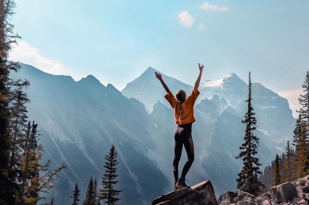 lady rucking and looking over a mountain