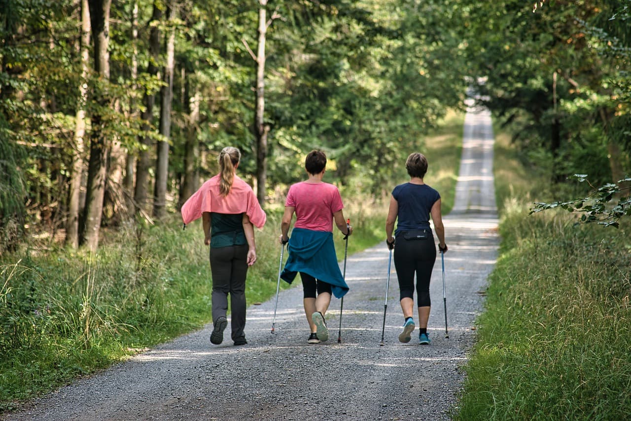 Active adults walking outdoors to improve mobility, wellness, strength, and healthy aging
