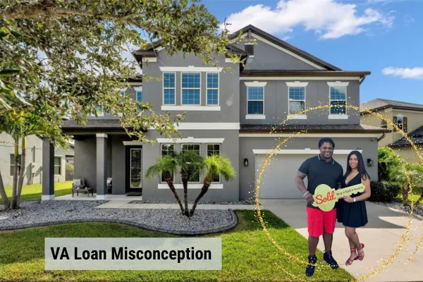 View of two home buyers in front of their new home, which is a two story gray block construction home with 2 car garage and driveway. 