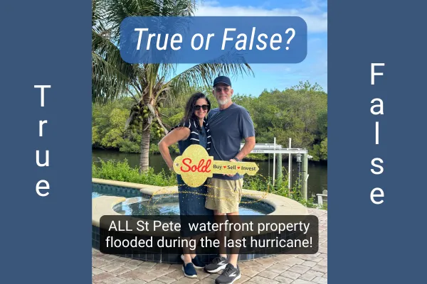 Happy buyers David and Jessica at their newly purchased flood-free waterfront pool home in St. Petersburg, FL, holding a Sold sign with mangrove waterway and dock in the background