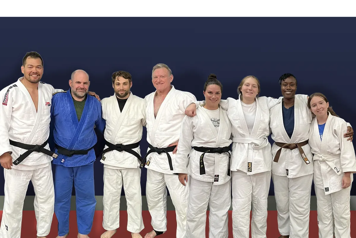 Adult practitioners engaged in active judo randori on the mat