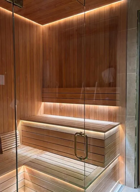 A wooden room with a bench and a sink