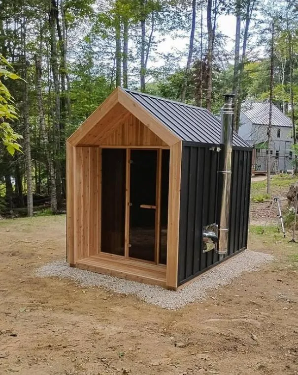 A woman sitting in a sauna with a towel on