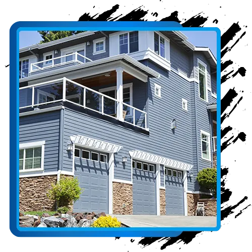 Exterior of a blue and gray house with siding and trim, showcasing residential painting services.