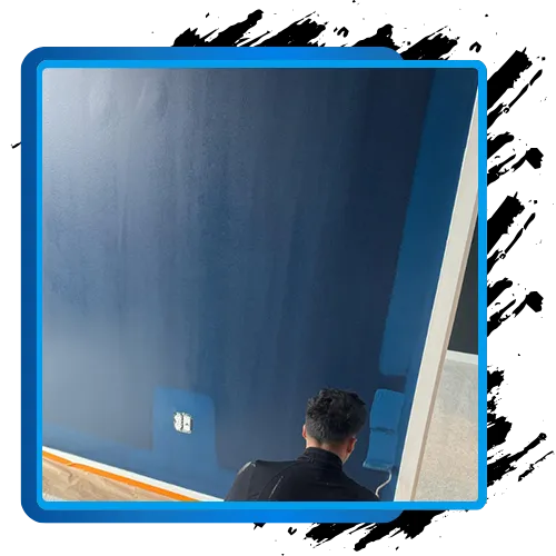 Professional painter applying blue interior paint in Bethesda, MD