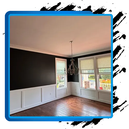 Interior painting project with dark walls and white trim, showcasing professional painting services.