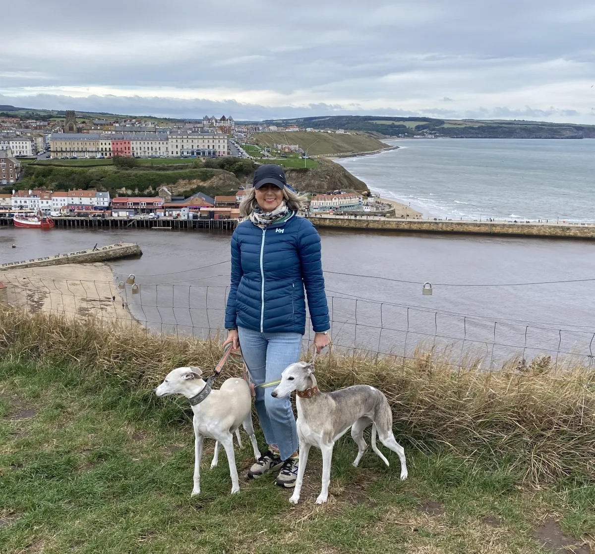Person sitting on a wooden bench overlooking a tranquil beach, reflecting on emotions and se inner peace amidst grief an