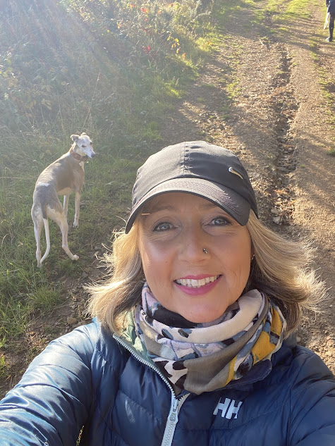 Calm, welcoming coach sitting with tea and journal